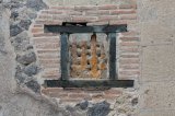 Window with wooden frame and iron bars in House of the Alcove, Herculaneum