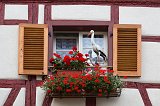 Window with Stork Ornaments and Geraniums, Eguisheim, Alsace, France